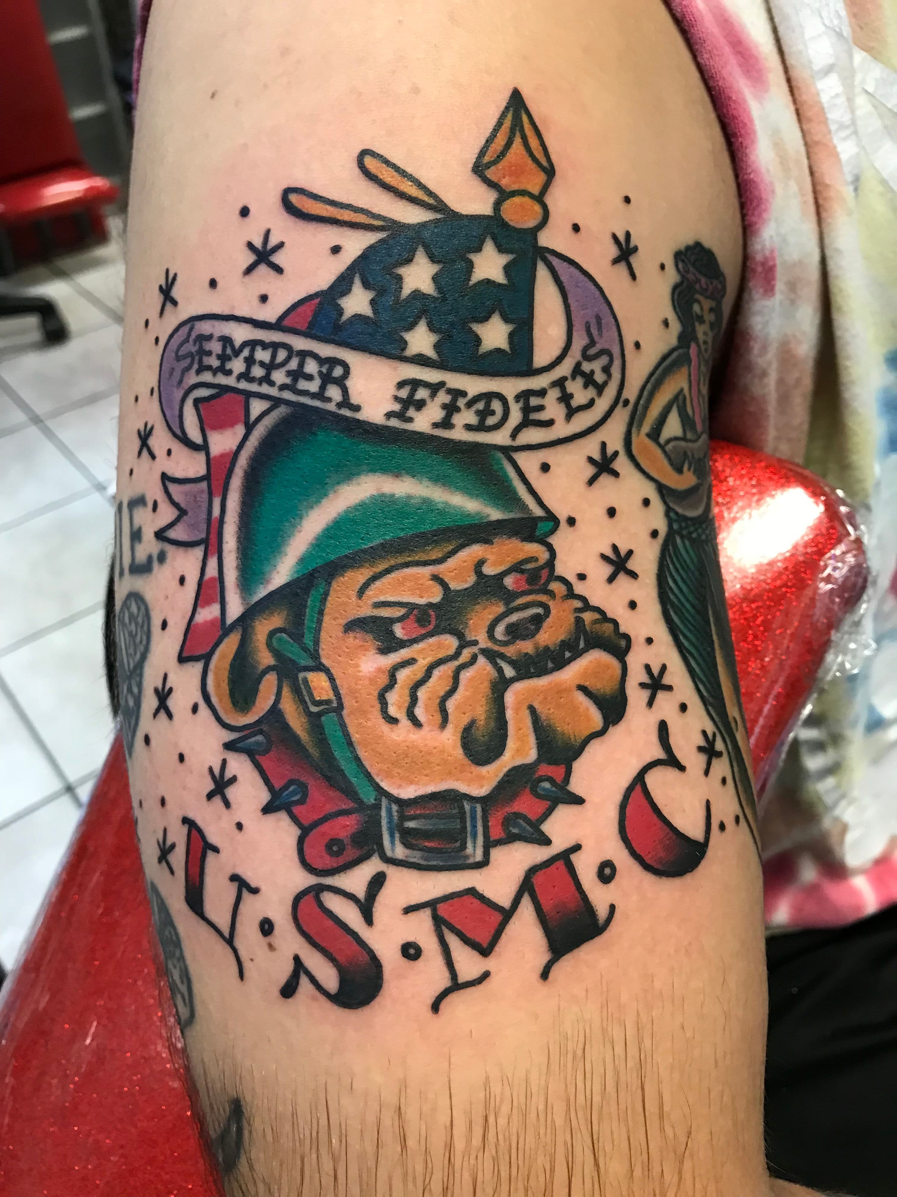 USMC bulldog tattoo with banner and helmet on upper arm